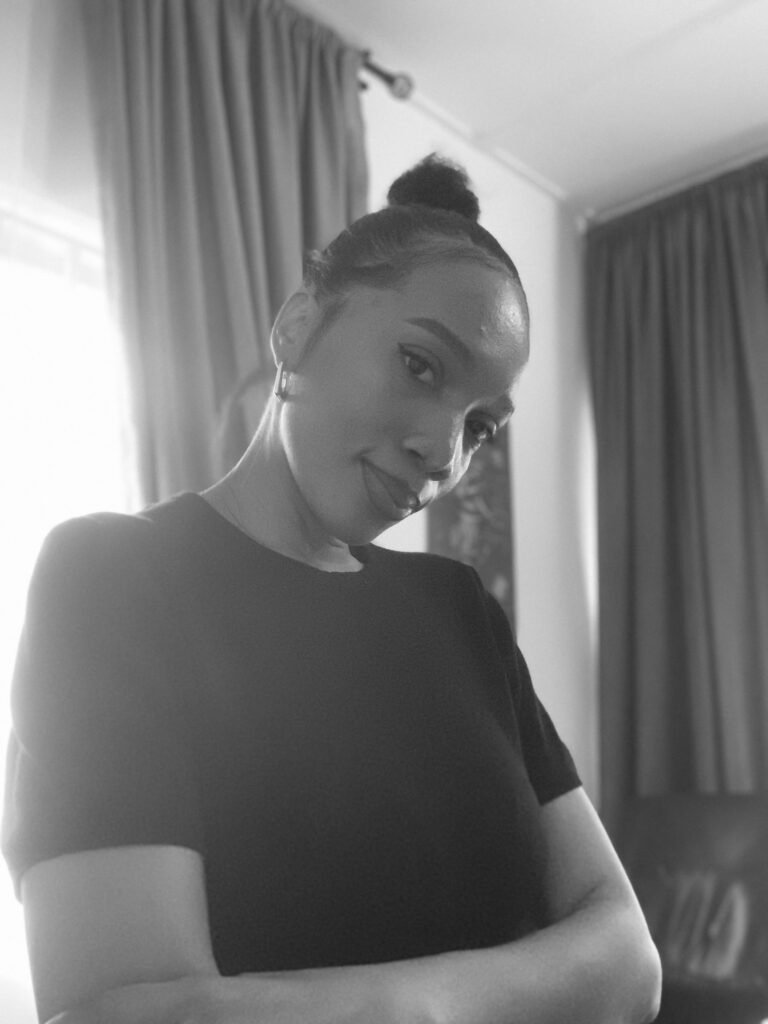 About our creative member in a black shirt standing.